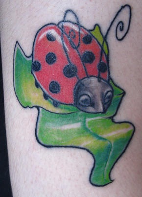 Cartoonish ladybug on green leaf - Tattooimages.biz